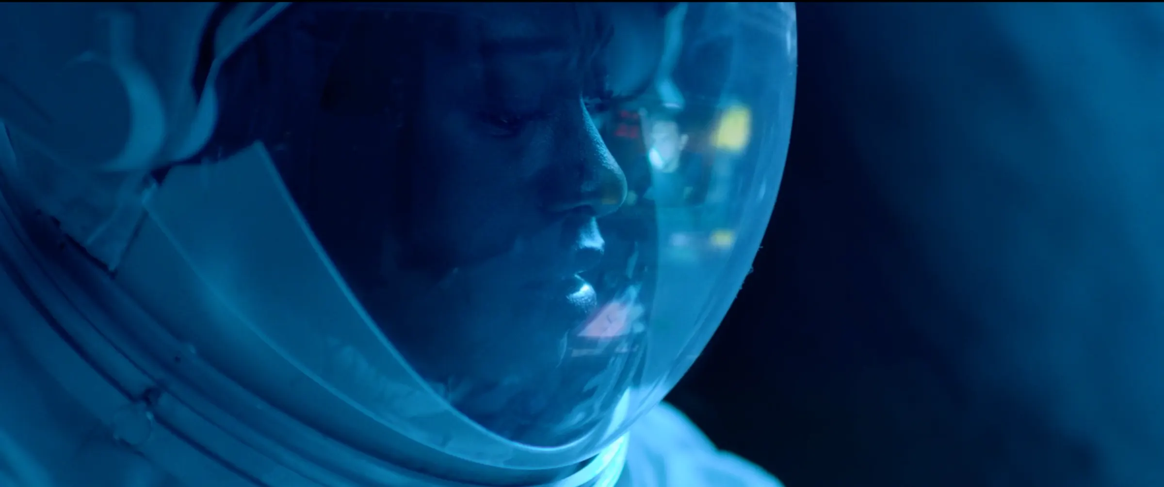 The astronaut’s face behind a frosted visor.