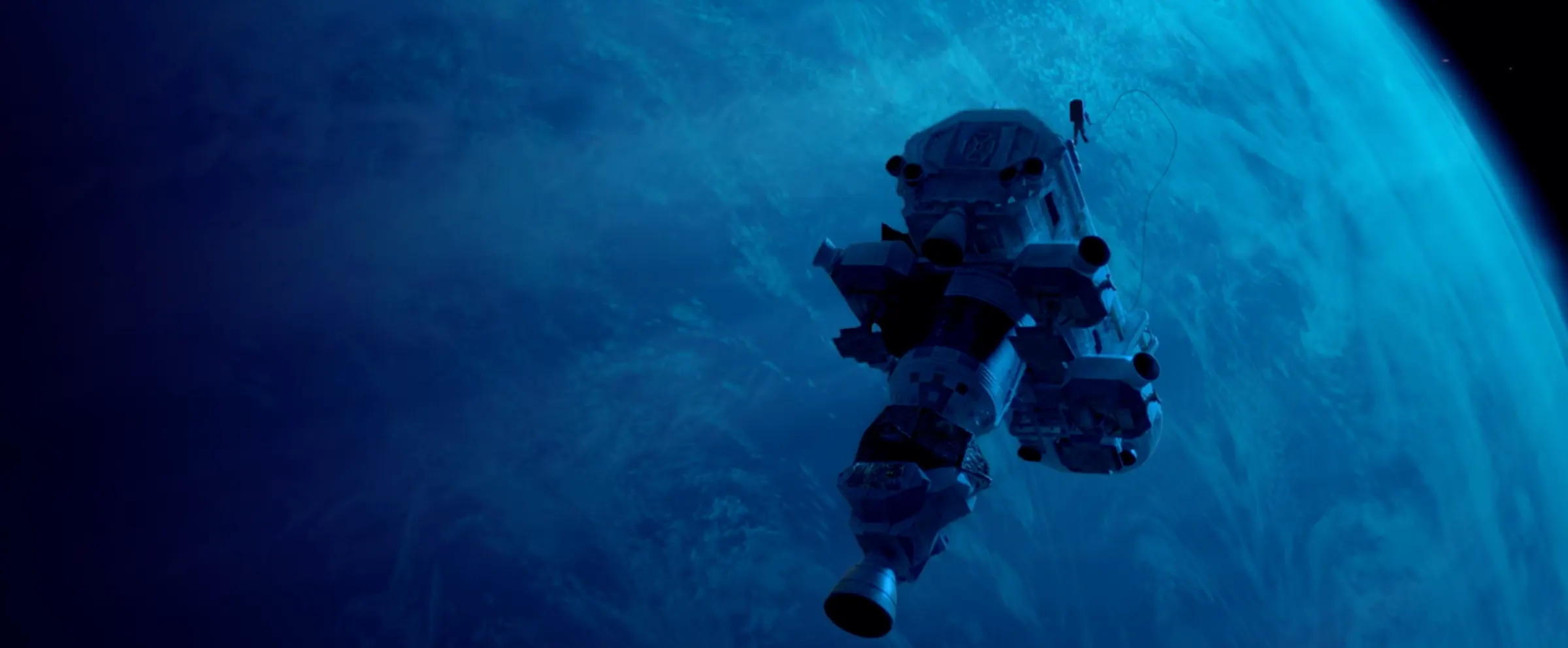 A spacecraft drifts above a blue planet.