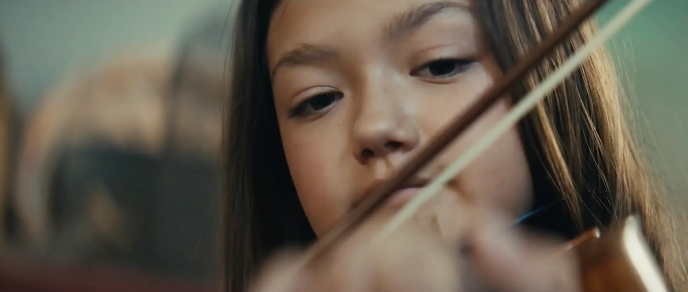 Close-up of the young violinist mid-performance.